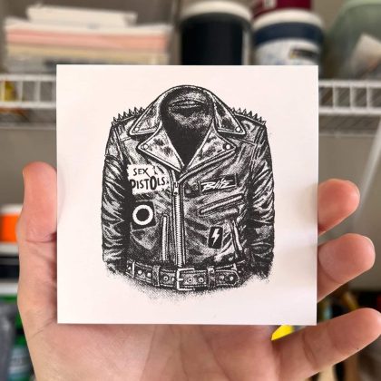 Mini punk screen print held in hand, showing scale and single-color halftone leather jacket design.