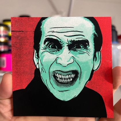 Hand holding Nicolas Cage Renfield mini horror screen print to show artwork size and scale.