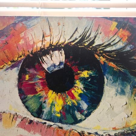 Close-up of the CMYK Eye Painting screen print displayed upright, showing detailed halftone dots and layered colors.