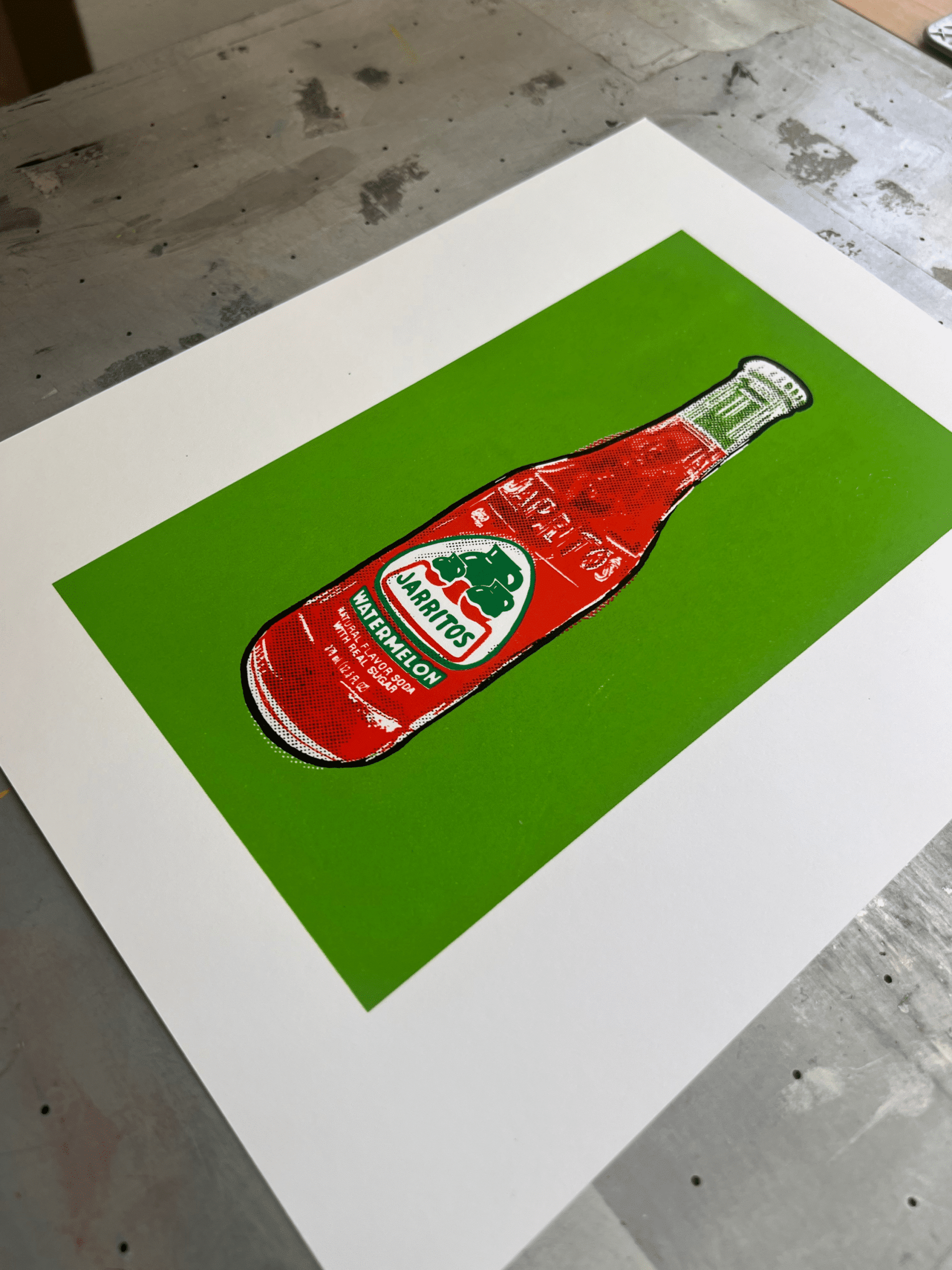 Angled flat lay of a handmade Jarritos watermelon bottle screen print with a bright lime green background.