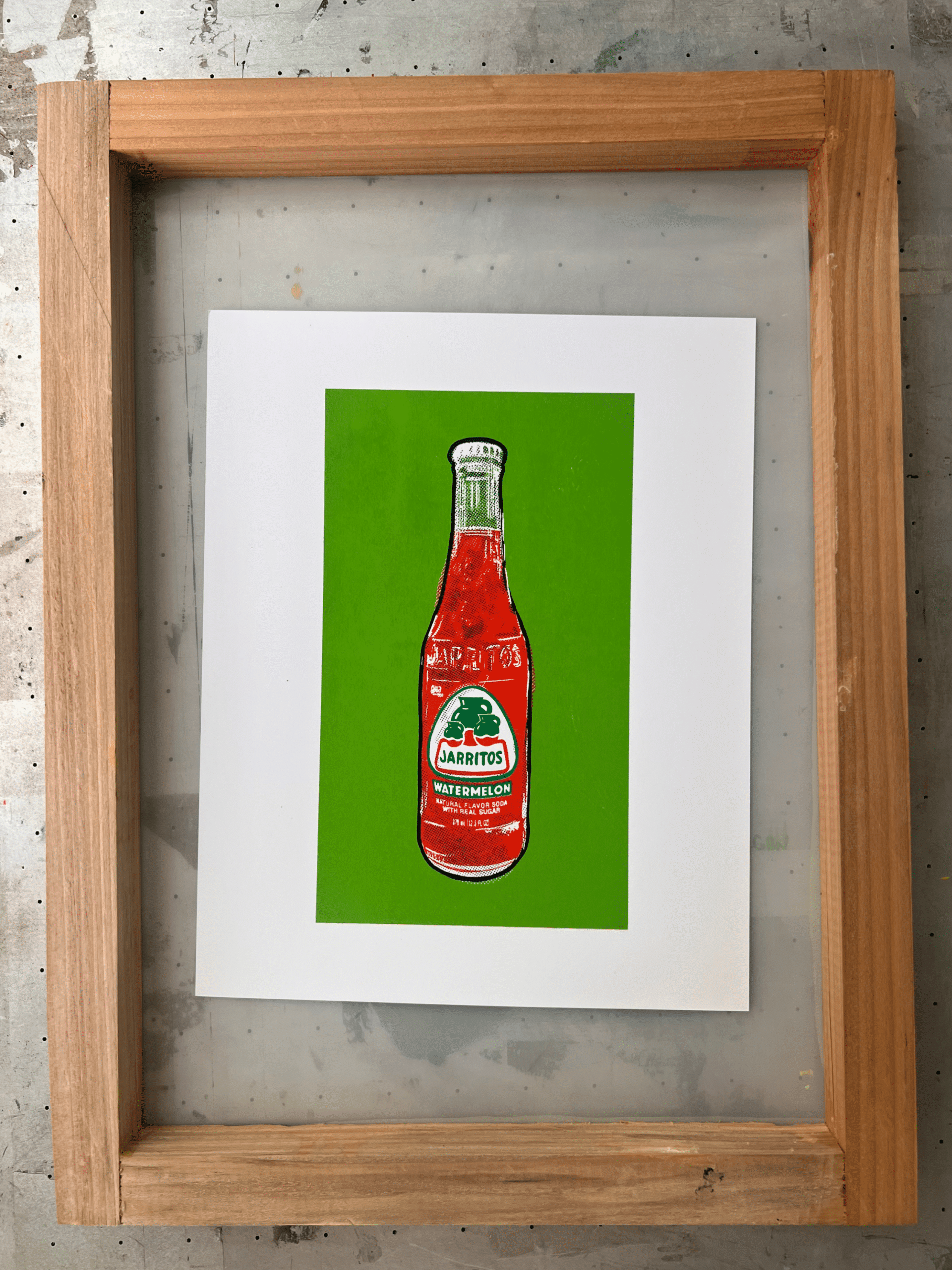 Finished Jarritos watermelon artwork displayed on the screen-printing screen used during the handmade process.